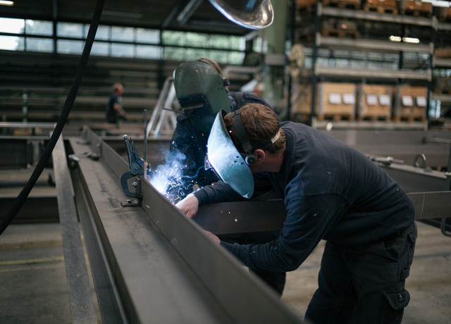 Two production workers are welding side by side in our workshop.