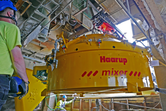 2 fitters working to install a mixer in an upgraded concrete plant 