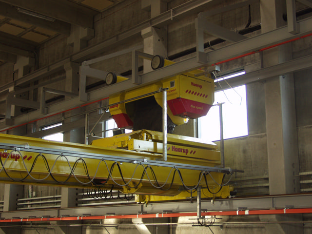 Half-gantry shown at a production facility being facilitated by a dual rail concrete travelling bucket.