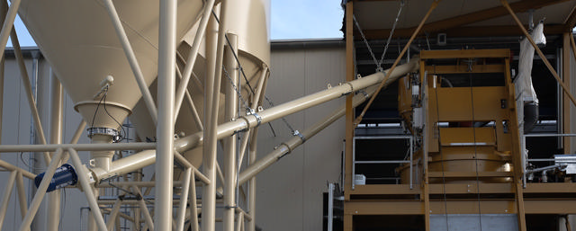 Two screw conveyors feeding cement.