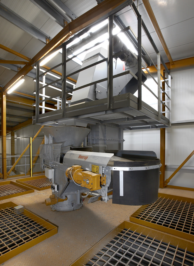 Bucket elevator shown inside a production facility.