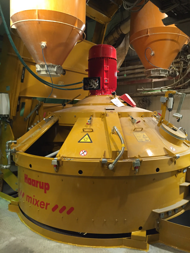 A new concrete mixer in the factory building of an upgraded plant.