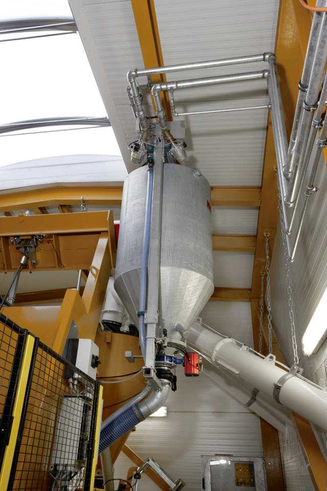 Water weigh hopper seen from below in a concrete producing facility.