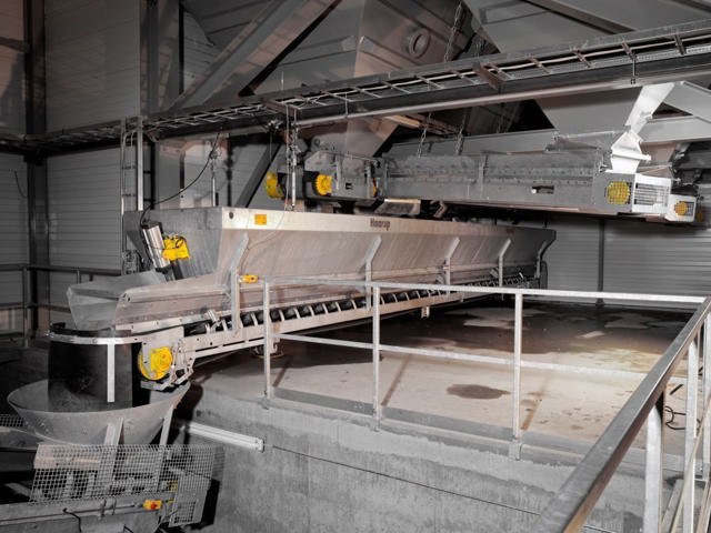 Weighing belt pictured in a grey production facility.